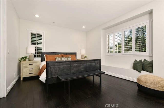 bedroom with recessed lighting, wood finished floors, and baseboards