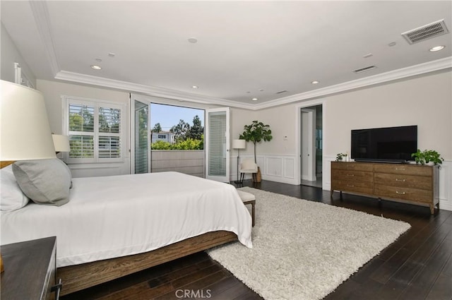 bedroom featuring a wainscoted wall, visible vents, and ornamental molding