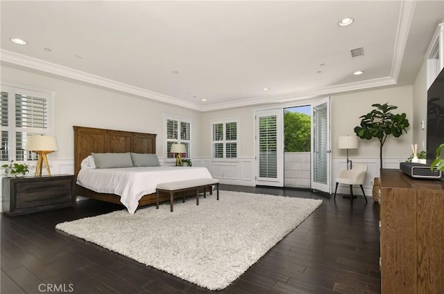 bedroom with wainscoting, ornamental molding, and access to exterior