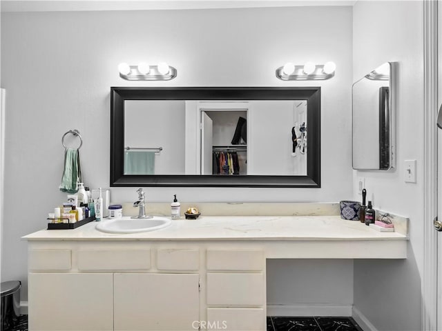 12720 Burbank Blvd Unit 323, Valley Village, CA 91607 - bathroom featuring baseboards, vanity, toilet, and a spacious closet