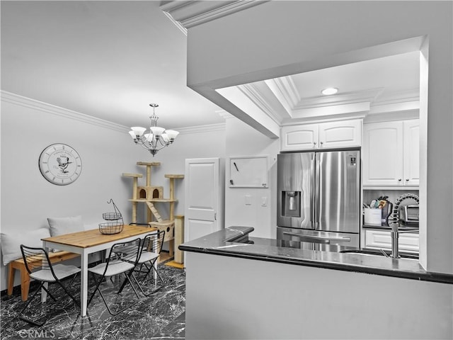 12720 Burbank Blvd Unit 323, Valley Village, CA 91607 - kitchen featuring stainless steel fridge, ornamental molding, white cabinets, dark marble finish floors, and decorative light fixtures