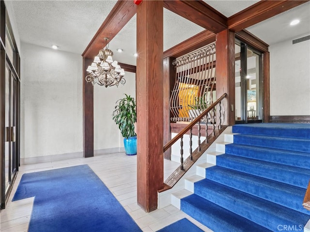 12720 Burbank Blvd Unit 323, Valley Village, CA 91607 - stairs featuring a textured ceiling and a chandelier
