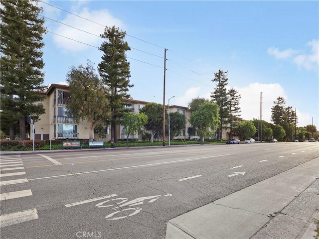 12720 Burbank Blvd Unit 323, Valley Village, CA 91607 - view of asphalt street with street lighting, sidewalks, and curbs