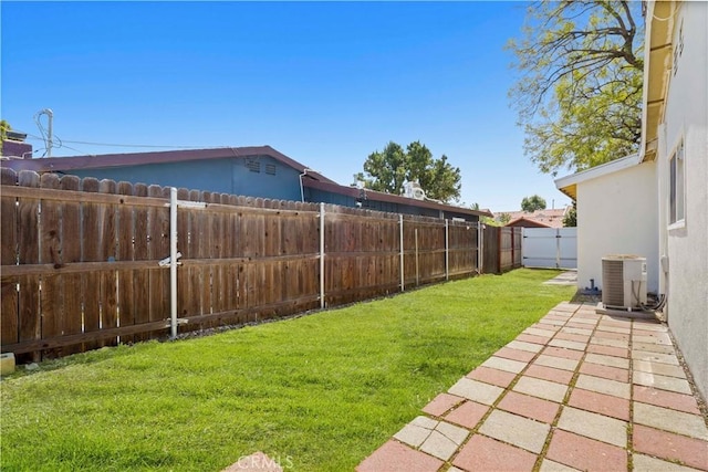 view of yard featuring central AC unit and a fenced backyard