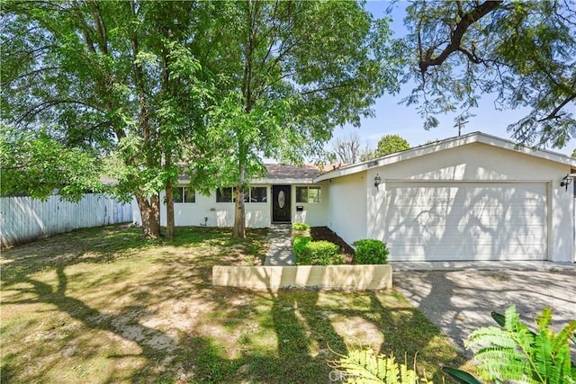 ranch-style home with an attached garage, driveway, stucco siding, and fence