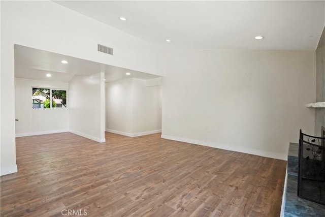 unfurnished living room featuring recessed lighting, visible vents, baseboards, and wood finished floors