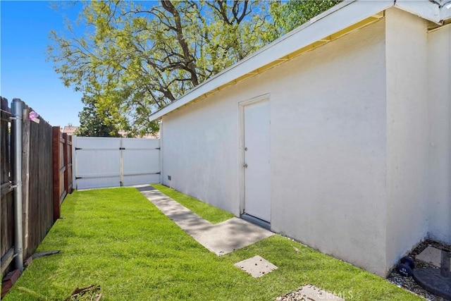 view of yard featuring fence and a gate