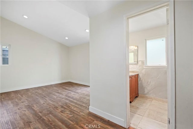 unfurnished room with recessed lighting, light wood-type flooring, and baseboards