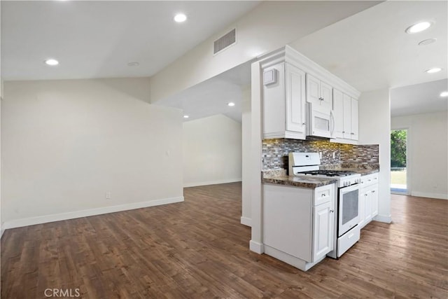 kitchen featuring visible vents, white cabinets, dark wood-style flooring, white appliances, and backsplash