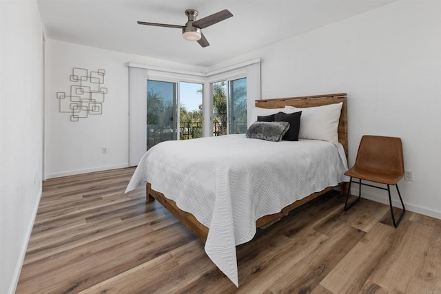 3421 Park Blvd Unit 401, San Diego, CA 92103 - bedroom featuring access to exterior, baseboards, wood finished floors, and a ceiling fan