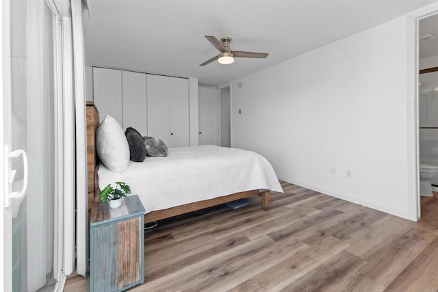 3421 Park Blvd Unit 401, San Diego, CA 92103 - bedroom featuring wood finished floors, a closet, ensuite bath, baseboards, and a ceiling fan