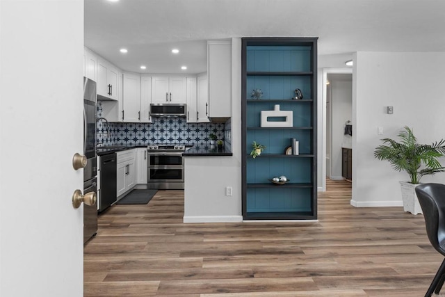 3421 Park Blvd Unit 401, San Diego, CA 92103 - kitchen with appliances with stainless steel finishes, dark countertops, dark wood-style flooring, white cabinetry, and recessed lighting