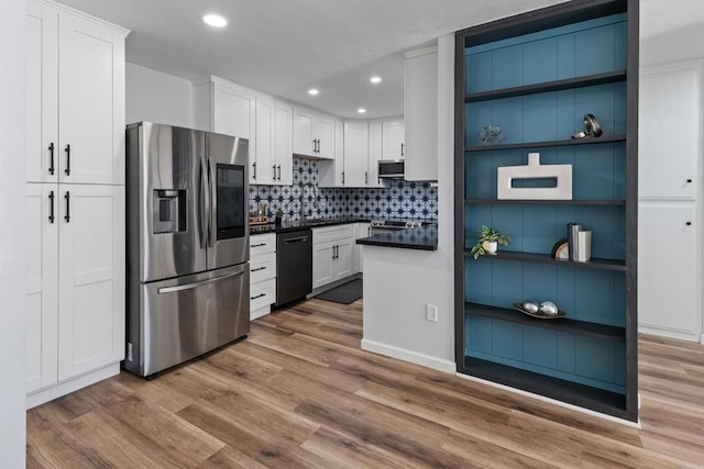 3421 Park Blvd Unit 401, San Diego, CA 92103 - kitchen featuring stainless steel appliances, dark countertops, wood finished floors, recessed lighting, and white cabinetry