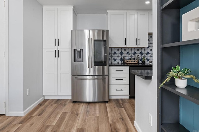 3421 Park Blvd Unit 401, San Diego, CA 92103 - kitchen featuring stainless steel fridge with ice dispenser, light wood-type flooring, dark countertops, tasteful backsplash, and recessed lighting