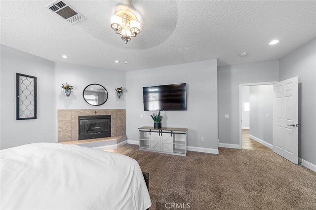 7922 Los Palmas Dr, Oak Hills, CA 92344 - bedroom featuring visible vents, recessed lighting, carpet floors, a tile fireplace, and baseboards