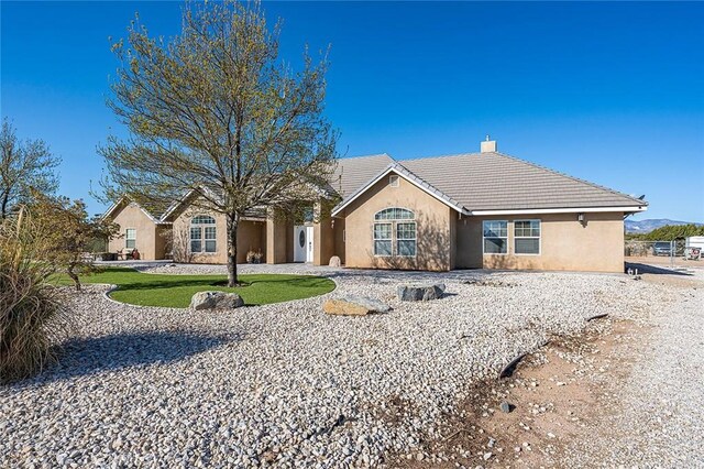 7922 Los Palmas Dr, Oak Hills, CA 92344 - ranch-style home featuring stucco siding, a chimney, and a tile roof