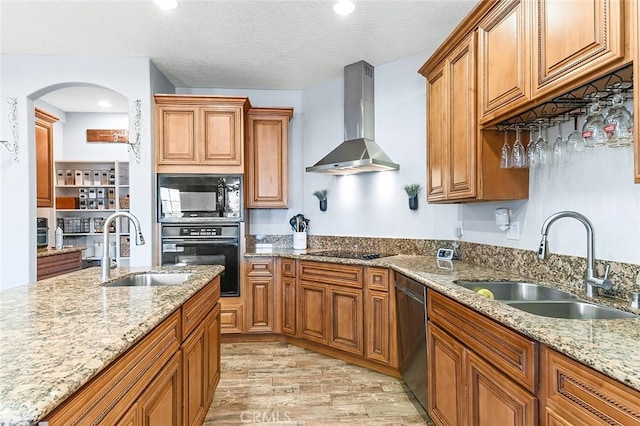 7922 Los Palmas Dr, Oak Hills, CA 92344 - kitchen featuring arched walkways, a sink, wall chimney exhaust hood, and black appliances