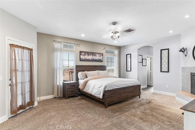 7922 Los Palmas Dr, Oak Hills, CA 92344 - bedroom featuring visible vents, baseboards, arched walkways, carpet, and a textured ceiling