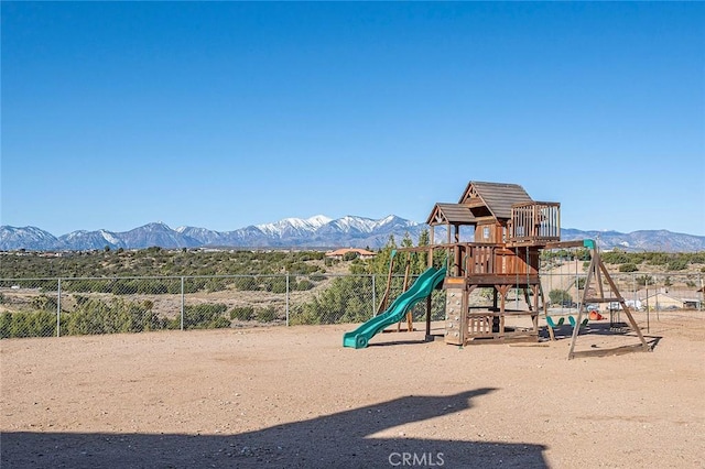 7922 Los Palmas Dr, Oak Hills, CA 92344 - communal playground featuring a mountain view and fence