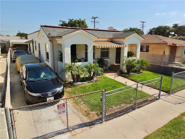 8912 Mettler St, Los Angeles, CA 90003 - view of front of house with a fenced front yard, stucco siding, a porch, a front lawn, and a gate