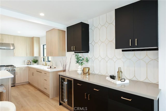 237 Canal St, Newport Beach, CA 92663 - kitchen featuring ventilation hood, beverage cooler, high end range, light brown cabinetry, and dark cabinets