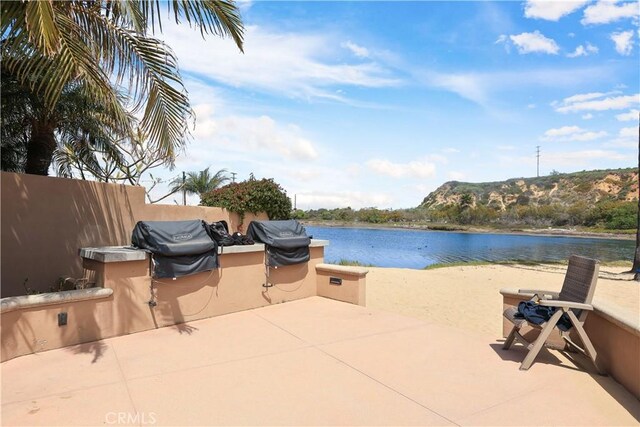 exterior space featuring a grill, area for grilling, and a water view