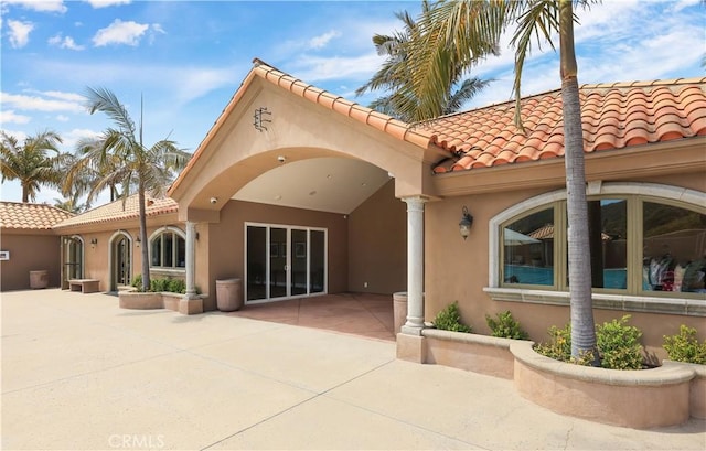 237 Canal St, Newport Beach, CA 92663 - rear view of property with stucco siding, a tiled roof, and a patio area