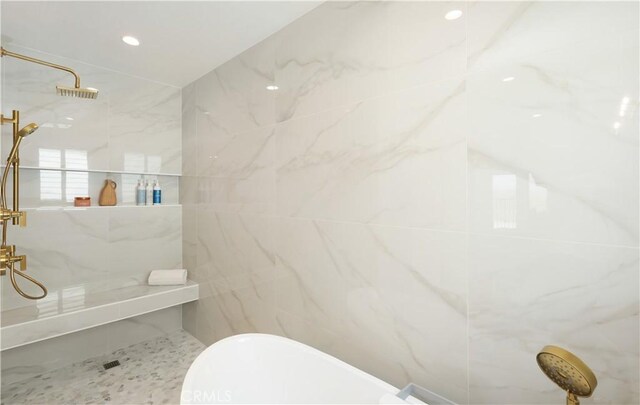 bathroom with a marble finish shower