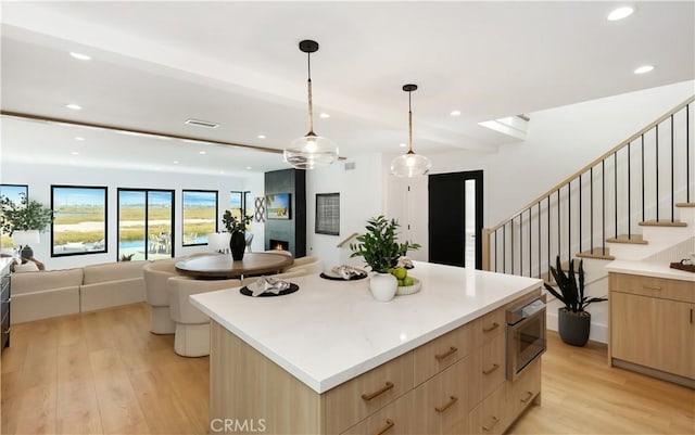 237 Canal St, Newport Beach, CA 92663 - kitchen featuring light brown cabinets, modern cabinets, light wood finished floors, open floor plan, and recessed lighting