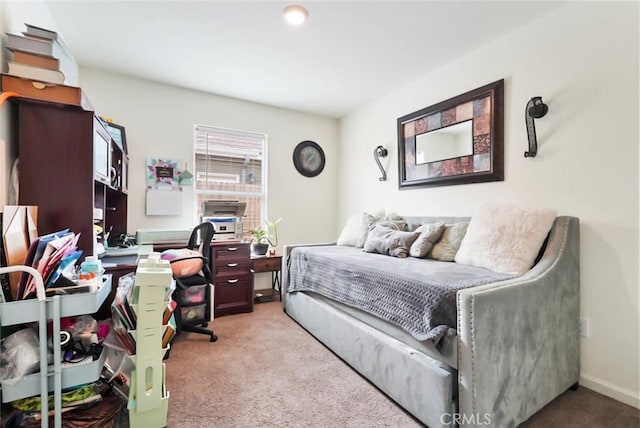 bedroom with light carpet and baseboards