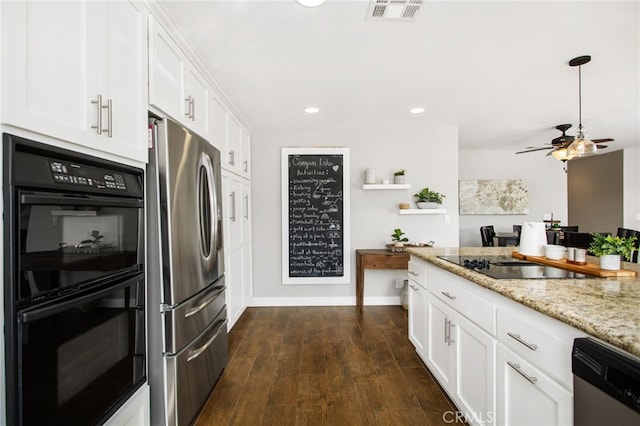 30249 Spray Dr, Canyon Lake, CA 92587 - kitchen featuring light stone counters, white cabinetry, visible vents, dark wood finished floors, and black appliances