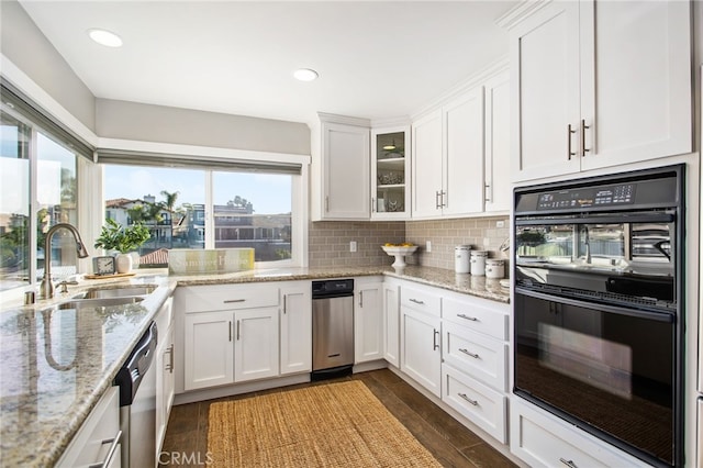 30249 Spray Dr, Canyon Lake, CA 92587 - kitchen featuring dobule oven black, white cabinetry, a sink, and backsplash