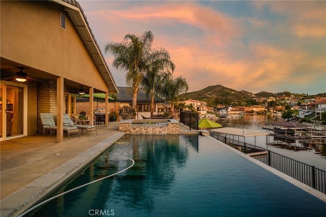 30249 Spray Dr, Canyon Lake, CA 92587 - view of swimming pool featuring a mountain view, a patio area, ceiling fan, a pool with connected hot tub, and fence