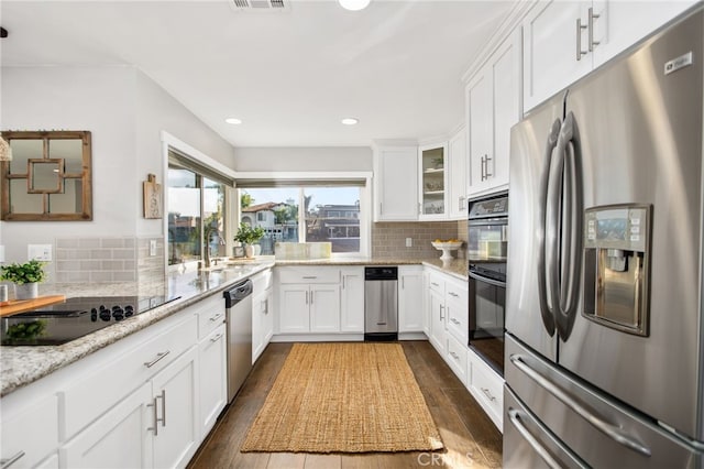 30249 Spray Dr, Canyon Lake, CA 92587 - kitchen with dark wood-style floors, appliances with stainless steel finishes, backsplash, and white cabinets