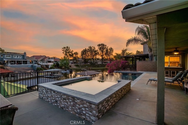 30249 Spray Dr, Canyon Lake, CA 92587 - pool at dusk featuring an outdoor pool, a residential view, an in ground hot tub, and a patio
