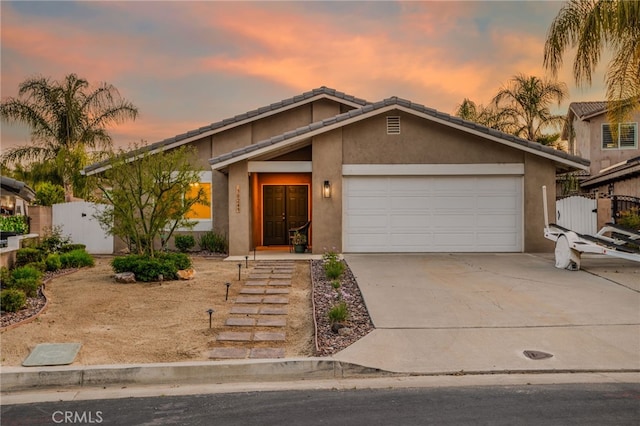 30249 Spray Dr, Canyon Lake, CA 92587 - mid-century inspired home featuring fence, a garage, stucco siding, and concrete driveway