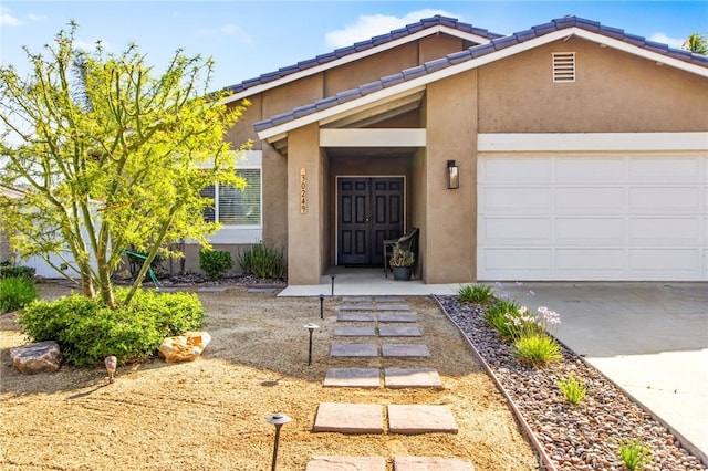 30249 Spray Dr, Canyon Lake, CA 92587 - view of front of house with a tiled roof, a garage, stucco siding, and driveway