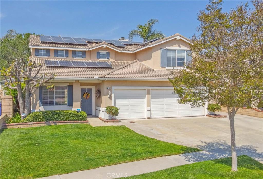 9130 Hamilton St, Rancho Cucamonga, CA 91701 - view of front of property featuring a tiled roof, driveway, stucco siding, and a front lawn