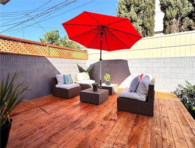 deck with an outdoor living space and fence