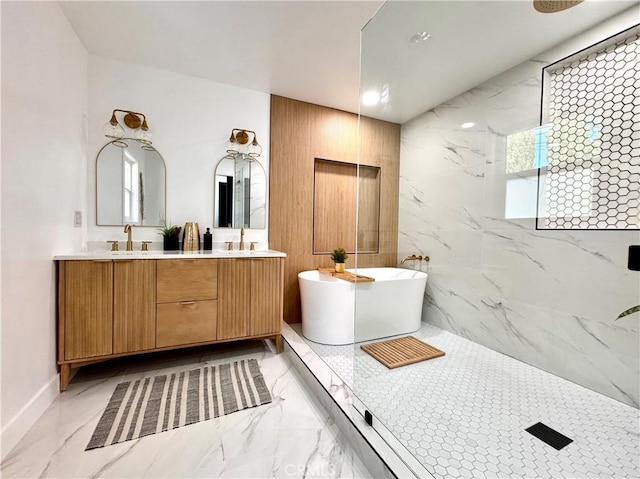 full bath with a freestanding tub, plenty of natural light, marble finish floor, and double vanity