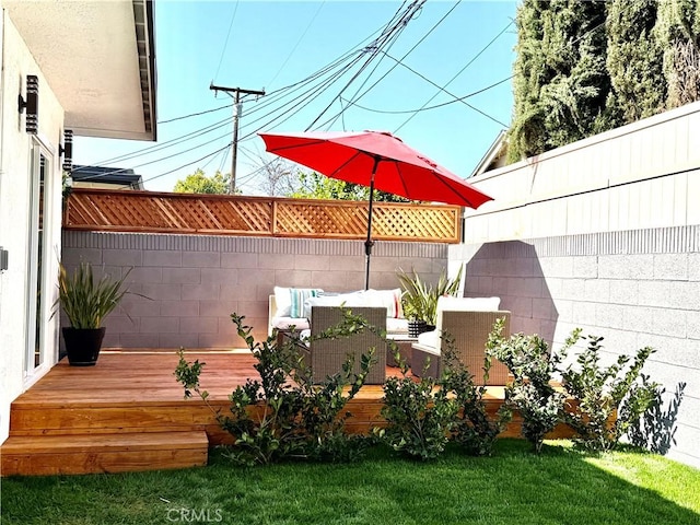 wooden deck featuring a yard and fence