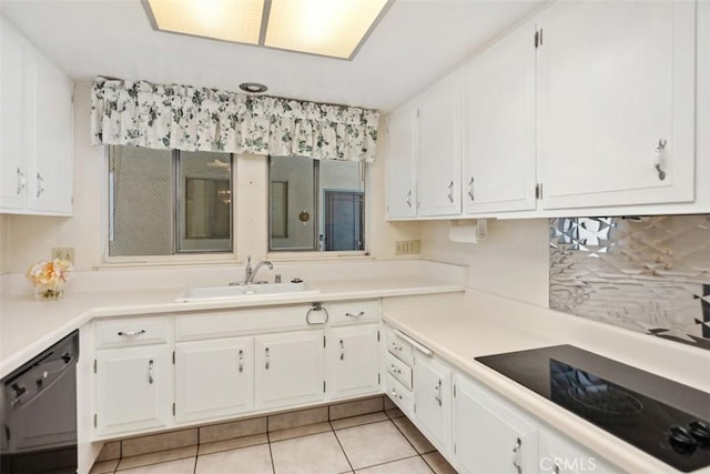 kitchen featuring black appliances, white cabinetry, and a sink