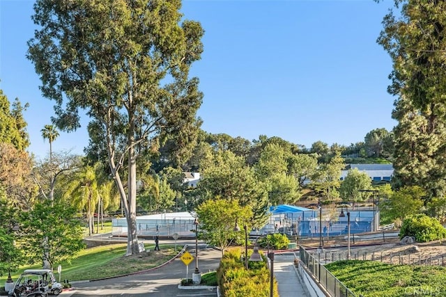 view of property's community featuring fence