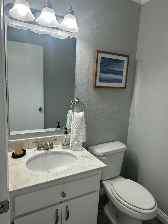 27130 Hidaway Ave Unit 6, Canyon Country, CA 91351 - bathroom featuring toilet, a textured wall, vanity, and baseboards