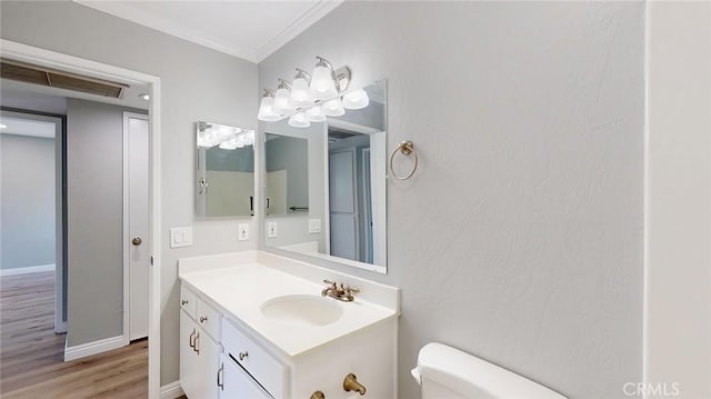 27130 Hidaway Ave Unit 6, Canyon Country, CA 91351 - bathroom with toilet, crown molding, wood finished floors, and vanity