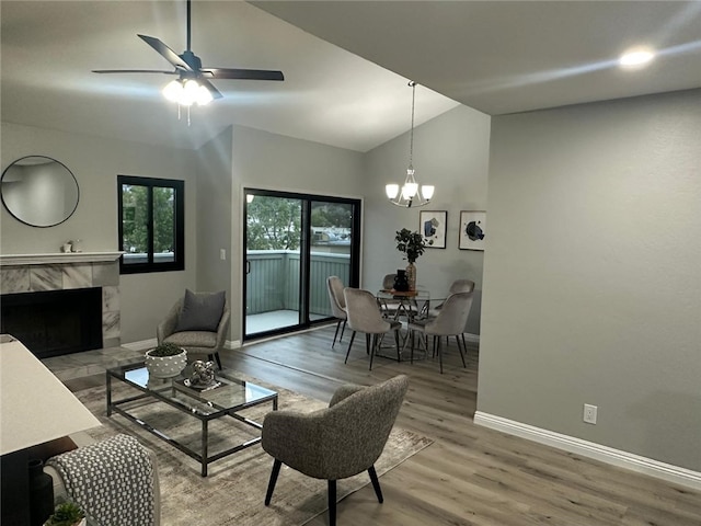 27130 Hidaway Ave Unit 6, Canyon Country, CA 91351 - living room with vaulted ceiling, a chandelier, light wood-type flooring, baseboards, and a tile fireplace