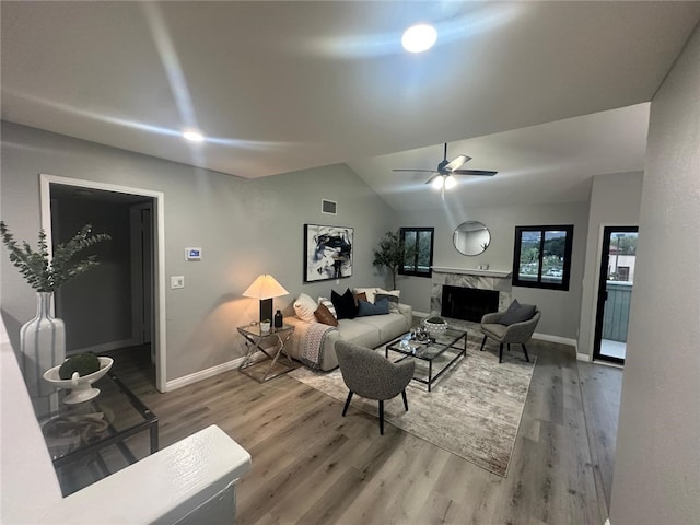 27130 Hidaway Ave Unit 6, Canyon Country, CA 91351 - living area with wood finished floors, a high end fireplace, baseboards, vaulted ceiling, and ceiling fan