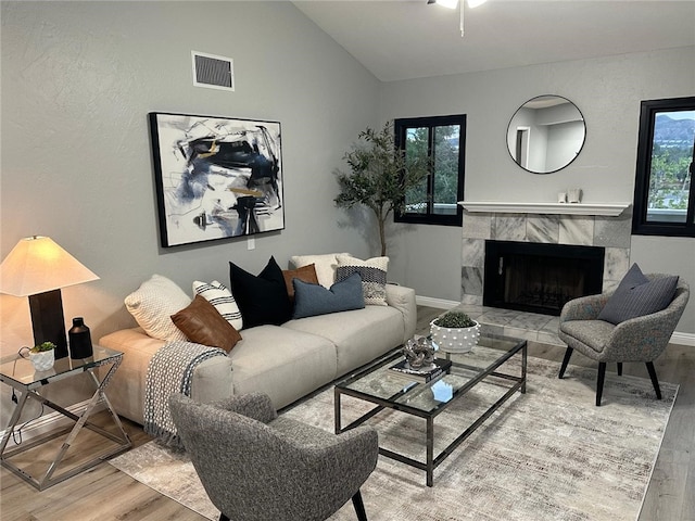 27130 Hidaway Ave Unit 6, Canyon Country, CA 91351 - living area with wood finished floors, a high end fireplace, lofted ceiling, and baseboards