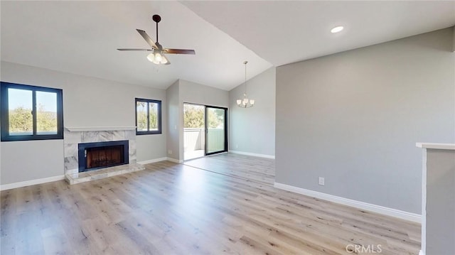 27130 Hidaway Ave Unit 6, Canyon Country, CA 91351 - unfurnished living room with a high end fireplace, ceiling fan, a chandelier, baseboards, and wood finished floors