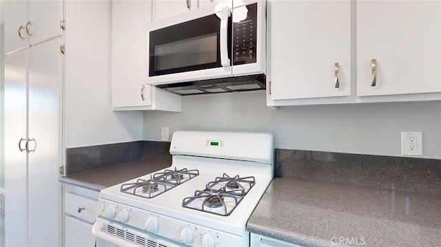 27130 Hidaway Ave Unit 6, Canyon Country, CA 91351 - kitchen featuring white appliances, white cabinetry, and dark countertops